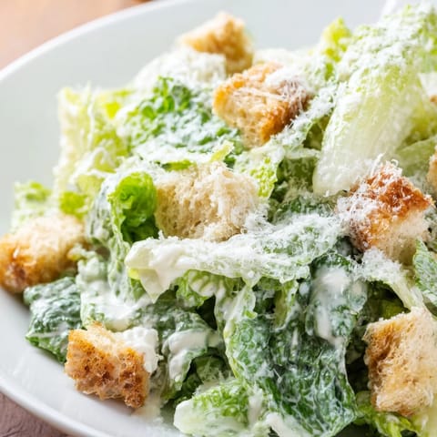 Crisp Caesar salad served in a wooden bowl, ready to be enjoyed as a light lunch or dinner side.