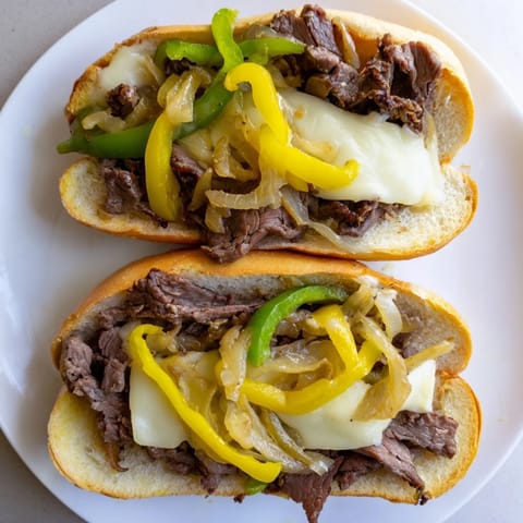 Gooey melted provolone coats tender ribeye and onions inside a toasted hoagie roll for this classic Philly Cheesesteak.