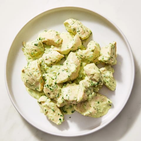 Sliced avocado ranch chicken salad with crisp celery, red onion, and herbs ready for a light lunch.