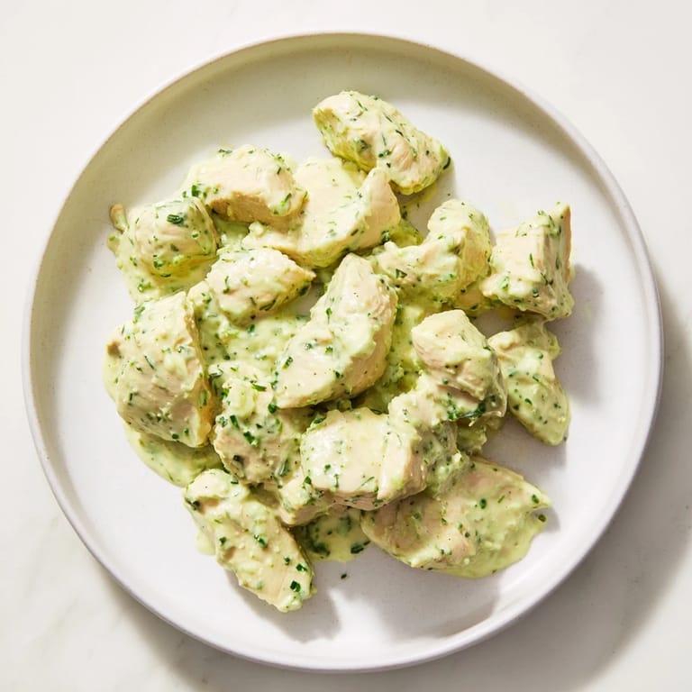 Sliced avocado ranch chicken salad with crisp celery, red onion, and herbs ready for a light lunch.