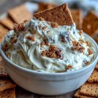 Creamy, dreamy cheesecake dip with graham crackers, perfect for parties or sweet cravings.  